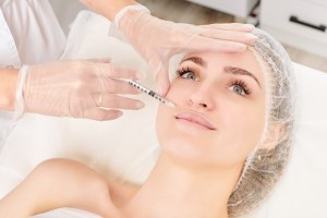 Woman getting lip filler injections