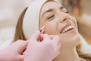 smiling woman getting botoz injections