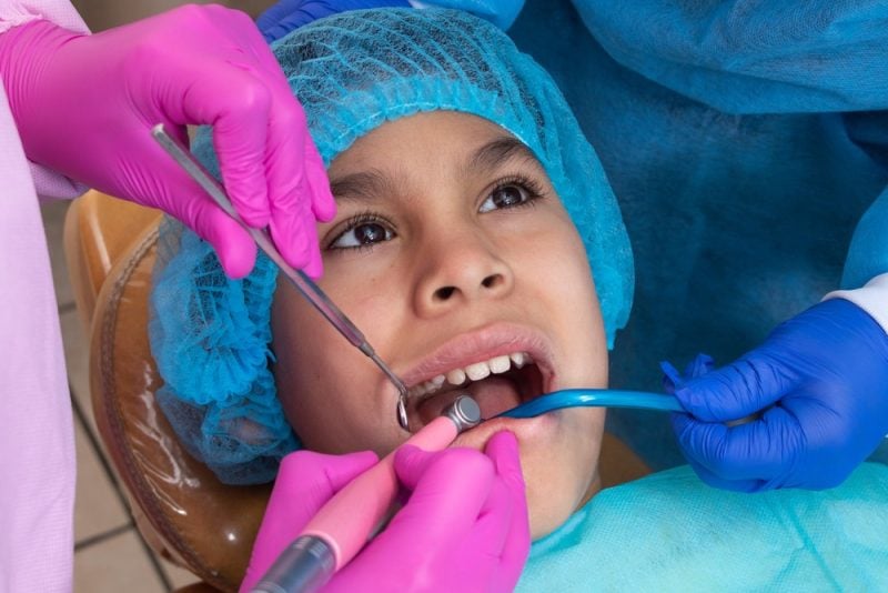 Boy getting checked by their dentist